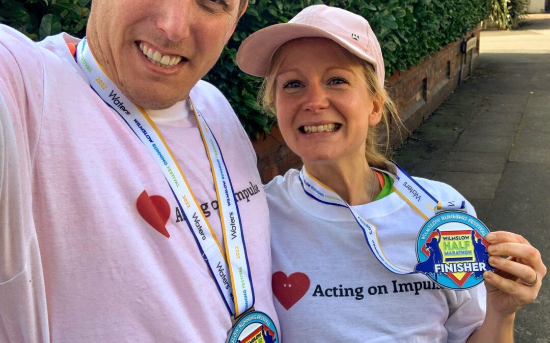 2 people smiling wearing medals