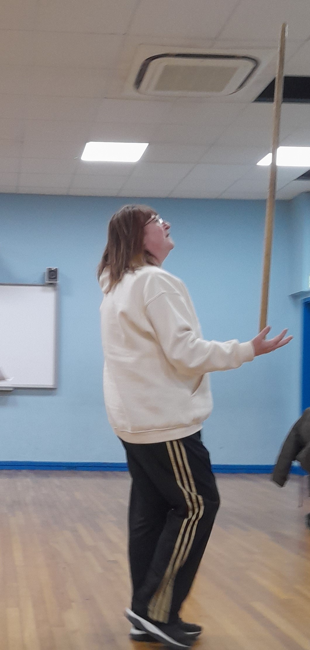 person balancing stick on hand
